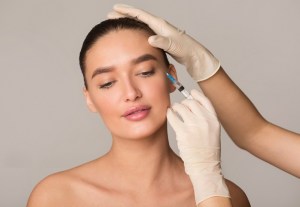 Applying botox to a patient 